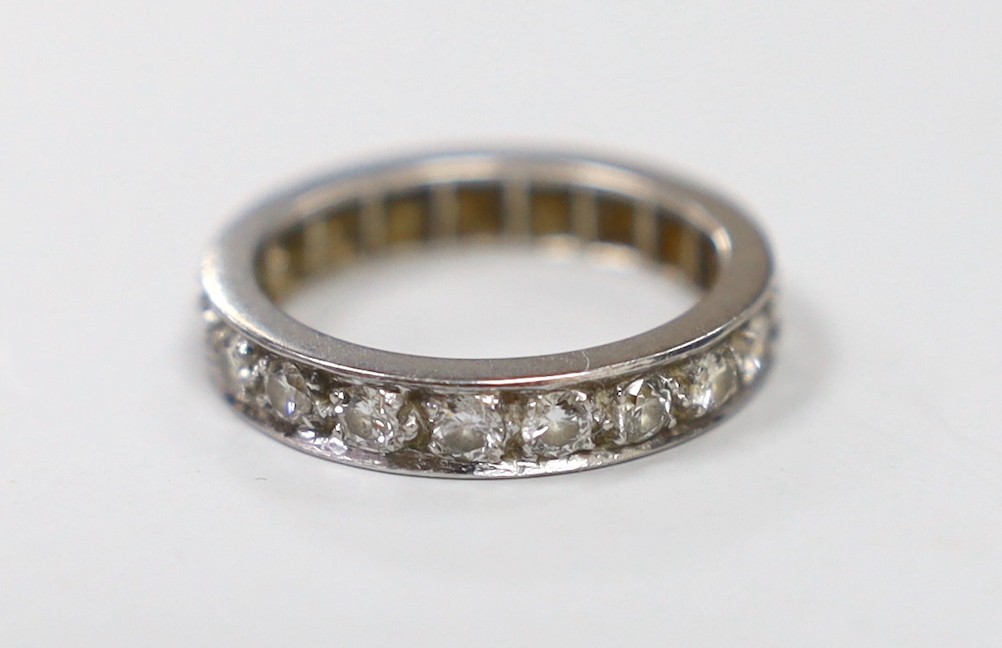 A white metal and diamond set full eternity ring, size J/K, gross weight 4.3 grams.